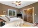 Bedroom with large window, ceiling fan, and closet with wooden doors at 17015 Oxbridge Rd, Monument, CO 80132