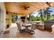 This covered patio offers dining and lounge areas with a fireplace and outdoor TV for relaxation at 17015 Oxbridge Rd, Monument, CO 80132