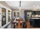 Cozy dining area with dark wood table and seating illuminated by modern pendant lighting, flowing from the kitchen at 17015 Oxbridge Rd, Monument, CO 80132