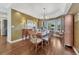 Formal dining room with a decorative chandelier, hardwood floors, and ample seating at 17015 Oxbridge Rd, Monument, CO 80132