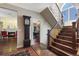 Grand foyer featuring hardwood floors, a staircase, and a view into the living room with a fireplace at 17015 Oxbridge Rd, Monument, CO 80132