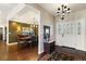 Grand foyer with hardwood floors, elegant lighting, and a view into the formal dining room sets a sophisticated tone at 17015 Oxbridge Rd, Monument, CO 80132