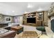 Game room with ping pong table, stone fireplace, and a custom built-in bookcase with television at 17015 Oxbridge Rd, Monument, CO 80132