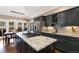 Modern kitchen boasting granite countertops, dark cabinetry, stainless steel appliances, and access to the outdoor patio at 17015 Oxbridge Rd, Monument, CO 80132
