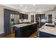 Modern kitchen features dark cabinetry, granite countertops, stainless steel appliances, and an island with a gas cooktop at 17015 Oxbridge Rd, Monument, CO 80132