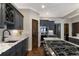 Gourmet kitchen featuring dark wood cabinetry, a kitchen island, granite counters and stainless-steel appliances at 17015 Oxbridge Rd, Monument, CO 80132