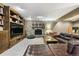 Spacious living room featuring a stone fireplace and custom built-ins at 17015 Oxbridge Rd, Monument, CO 80132
