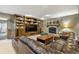 Cozy living room features a stone fireplace, built-in bookshelves and comfortable seating at 17015 Oxbridge Rd, Monument, CO 80132