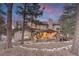 Beautiful rear exterior with a stone patio, outdoor kitchen and a spacious deck at 17015 Oxbridge Rd, Monument, CO 80132
