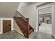 Basement staircase with wooden steps and iron railing, leading to an open doorway at 17015 Oxbridge Rd, Monument, CO 80132