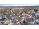 Aerial view showcasing a neighborhood's winter landscape, featuring houses and snowy terrain at 17364 W 63Rd Dr, Arvada, CO 80403