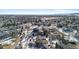 Aerial view of neighborhood with houses and snowy streets, distant mountains visible at 17364 W 63Rd Dr, Arvada, CO 80403