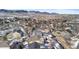 Wide aerial view of a residential area, showing houses, streets, and a mountainous landscape at 17364 W 63Rd Dr, Arvada, CO 80403