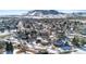 Aerial view of a residential area with houses covered in snow, mountain background at 17364 W 63Rd Dr, Arvada, CO 80403