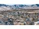 Aerial view of houses in a neighborhood during winter, with mountain backdrop at 17364 W 63Rd Dr, Arvada, CO 80403