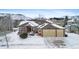 Aerial view of house and neighborhood in snowy landscape at 17364 W 63Rd Dr, Arvada, CO 80403