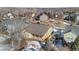 Aerial view of a house with backyard patio, surrounded by other homes in a snowy neighborhood at 17364 W 63Rd Dr, Arvada, CO 80403