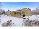 Covered patio and fenced backyard in the snow at 17364 W 63Rd Dr, Arvada, CO 80403