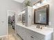 Double vanity bathroom with a walk-in closet at 17364 W 63Rd Dr, Arvada, CO 80403