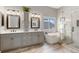 Bathroom with double vanity, soaking tub, and shower at 17364 W 63Rd Dr, Arvada, CO 80403