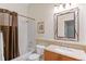 Clean bathroom, shower/tub combo, wood vanity, and mirror at 17364 W 63Rd Dr, Arvada, CO 80403