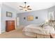 Comfortable bedroom with wood dresser and ceiling fan at 17364 W 63Rd Dr, Arvada, CO 80403