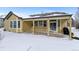 House exterior featuring a covered patio, and snowy yard at 17364 W 63Rd Dr, Arvada, CO 80403