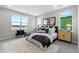 Inviting bedroom with a plush bed, large windows offering serene views, and stylish modern decor at 890 Coal Bank Trl, Castle Rock, CO 80104