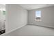 Neutral bedroom featuring a large window, plush carpet, and ensuite bathroom at 890 Coal Bank Trl, Castle Rock, CO 80104