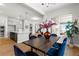 Open dining room with modern lighting, views of the kitchen and access to the backyard at 890 Coal Bank Trl, Castle Rock, CO 80104