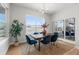 Dining room featuring stylish decor, a large window with backyard views and a modern light fixture at 890 Coal Bank Trl, Castle Rock, CO 80104