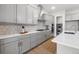 Modern kitchen featuring stainless steel appliances, grey cabinets, and quartz countertops at 890 Coal Bank Trl, Castle Rock, CO 80104