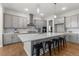 Spacious kitchen featuring quartz countertops, stainless steel appliances and eat-in island seating at 890 Coal Bank Trl, Castle Rock, CO 80104
