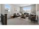 Upstairs living room with plush gray sofas, large bright windows, and a cozy carpeted area for relaxation at 890 Coal Bank Trl, Castle Rock, CO 80104