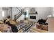 Open-concept living room with modern fireplace and view of the staircase at 890 Coal Bank Trl, Castle Rock, CO 80104