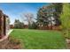 Expansive backyard with lush green grass, mature trees, and wooden fence creating a private outdoor space at 5164 E Princeton Ave, Cherry Hills Village, CO 80113