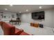 Finished basement with built-in shelving, entertainment area, and ample lighting at 5164 E Princeton Ave, Cherry Hills Village, CO 80113