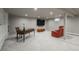 Finished basement with built-in shelving, entertainment area, and ample lighting at 5164 E Princeton Ave, Cherry Hills Village, CO 80113