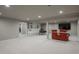 Finished basement with built-in shelving, entertainment area, and ample lighting at 5164 E Princeton Ave, Cherry Hills Village, CO 80113