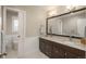 This bathroom features a double sink vanity with granite countertop, modern fixtures, and a separate toilet area at 5164 E Princeton Ave, Cherry Hills Village, CO 80113