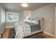 Bright bedroom featuring a neutral palette, natural light, and hardwood floors at 5164 E Princeton Ave, Cherry Hills Village, CO 80113