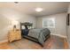 A cozy bedroom features a comfortable bed, a nightstand with lamp, and a patterned rug at 5164 E Princeton Ave, Cherry Hills Village, CO 80113