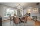 Formal dining room featuring a chandelier, a large bay window, and seating for six around a round table at 5164 E Princeton Ave, Cherry Hills Village, CO 80113