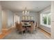 Elegant dining room with seating for six, a crystal chandelier, a bay window, and hardwood floors at 5164 E Princeton Ave, Cherry Hills Village, CO 80113