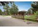 Charming exterior view of home with a covered patio, fenced yard, mature trees and manicured landscaping at 5164 E Princeton Ave, Cherry Hills Village, CO 80113
