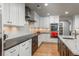 Well-appointed kitchen featuring stainless steel appliances, modern cabinetry, and a stylish range hood at 5164 E Princeton Ave, Cherry Hills Village, CO 80113
