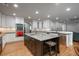 Bright, spacious kitchen featuring a large island, white cabinets, stainless steel appliances, and hardwood floors at 5164 E Princeton Ave, Cherry Hills Village, CO 80113