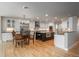 Large open kitchen featuring a stainless fridge, island, adjacent dining area, and hardwood flooring at 5164 E Princeton Ave, Cherry Hills Village, CO 80113