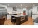 Modern kitchen features white cabinets, stainless steel appliances, and a central island with a built-in microwave at 5164 E Princeton Ave, Cherry Hills Village, CO 80113