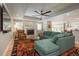 Bright living room with a large sectional, fireplace, tray ceiling with fan, hardwood flooring, and natural light at 5164 E Princeton Ave, Cherry Hills Village, CO 80113